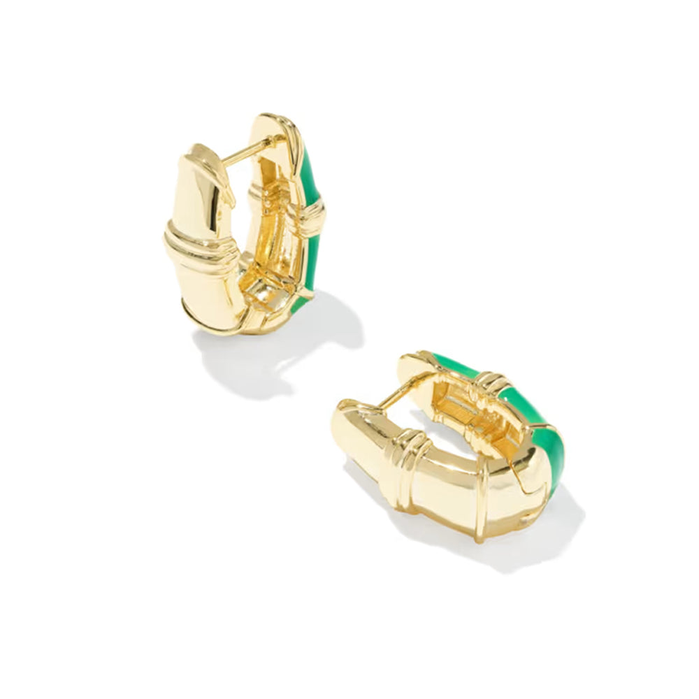 A pair of gold huggie hoop earrings with a vibrant green enamel inlay, displayed on a clean white background.