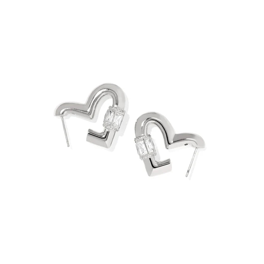 A pair of silver-toned geometric earrings with a curved, open heart-like shape and clear rectangular gemstones, shown on a plain white background.