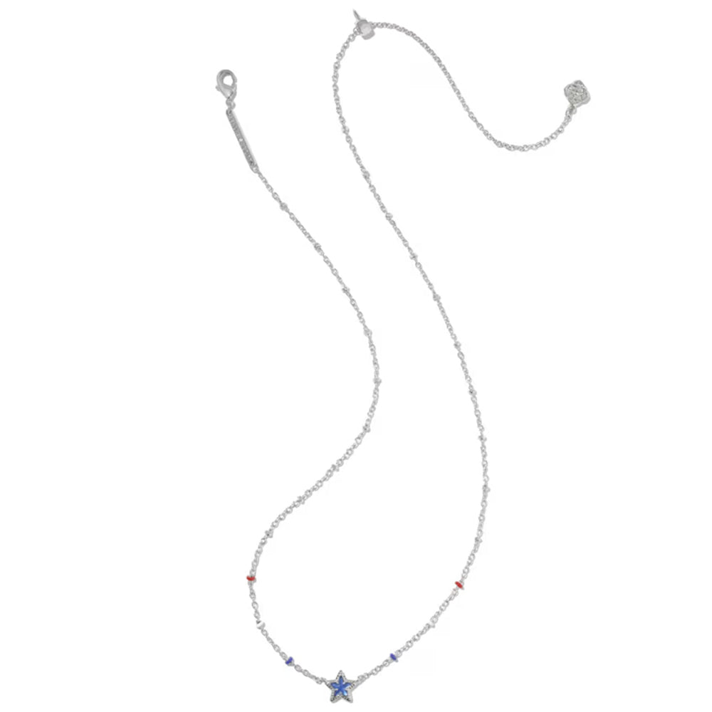 A delicate silver-toned chain necklace featuring a small blue star charm at the center, accented with tiny red and blue beads, displayed on a solid white background.