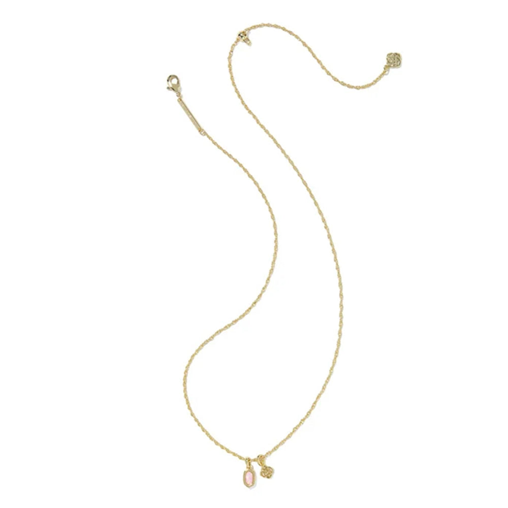 A delicate gold chain necklace featuring a small oval pink gemstone pendant and a tiny gold charm, displayed on a clean white background.