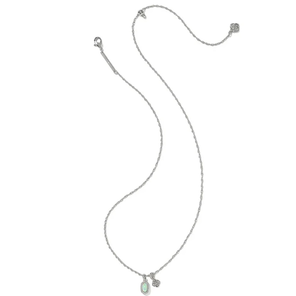 A delicate silver-toned chain necklace with a small oval light green gemstone pendant and a tiny matching stone accent, displayed on a solid white background.
