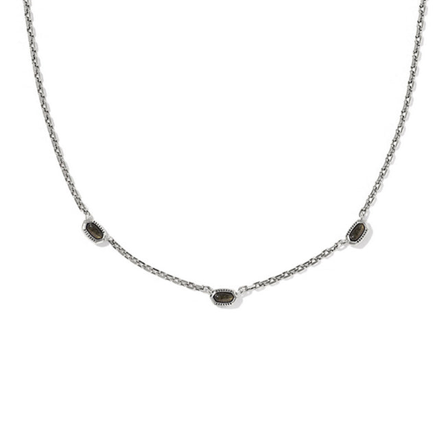 Necklace with small dark stones on a white background