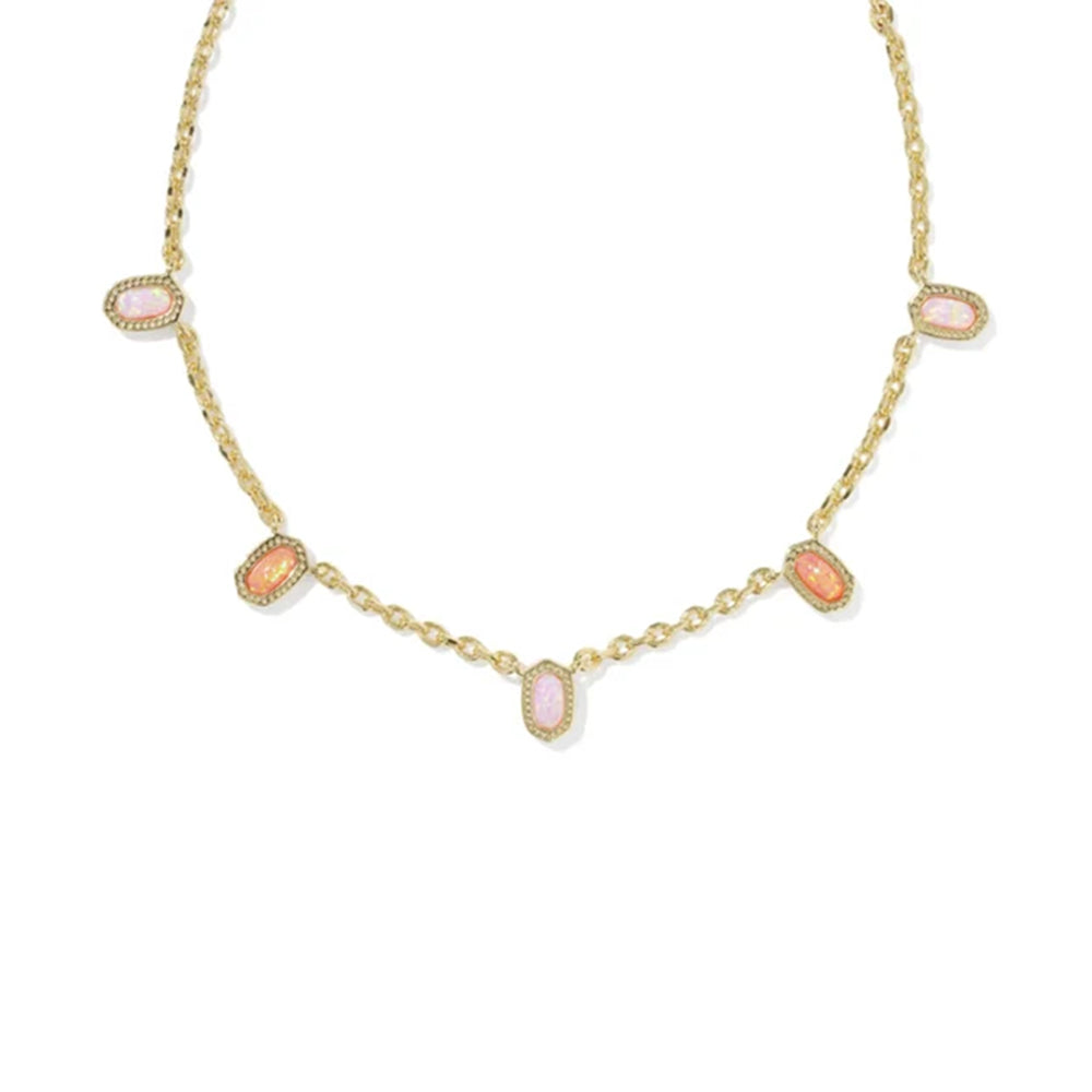 A gold chain necklace featuring five small, oval-shaped pink cabochon gemstones set in gold bezel settings, arranged symmetrically on a plain white background.