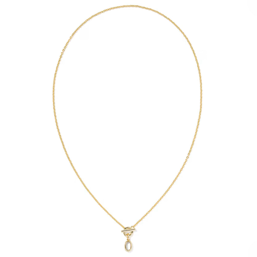 A delicate yellow gold chain necklace with a small geometric pendant and a teardrop-shaped clear gemstone, displayed on a clean white background.