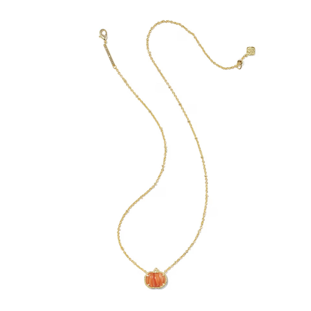 A delicate gold chain necklace featuring a small, textured orange pumpkin pendant with a clear crystal halo, displayed on a solid white background.
