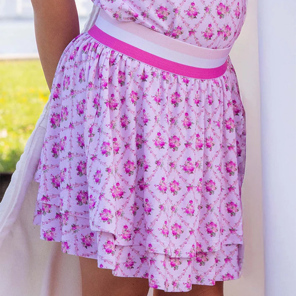 Pink floral dress with a white belt on a blurred background