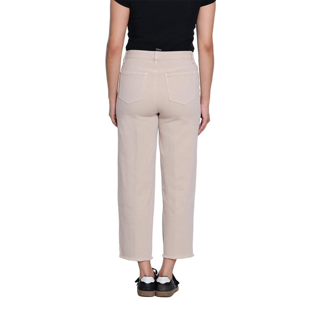 A person shown from the back wearing light beige cropped pants, a black top, and black shoes against a plain white studio background.