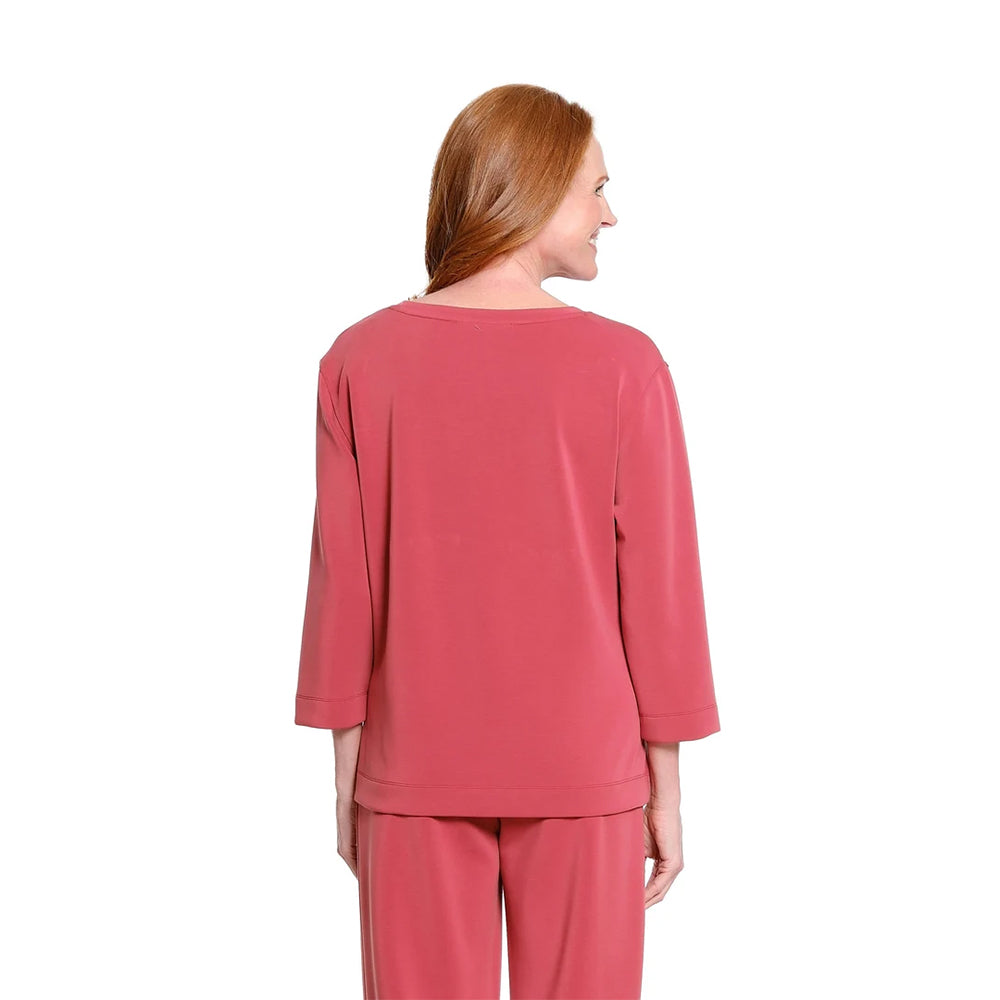 A woman with red hair is shown from the back wearing a matching dusty rose pink lounge set, consisting of a long-sleeve top and pants, against a plain white background.