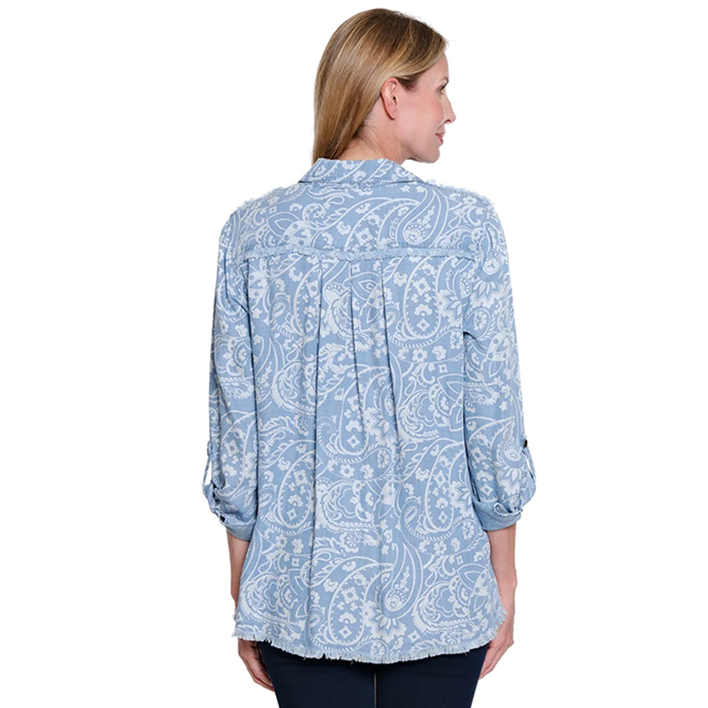 Woman wearing a blue paisley patterned shirt on a white background