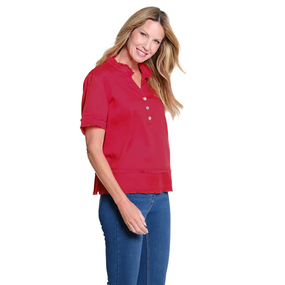 Woman wearing a red blouse and blue jeans on a white background