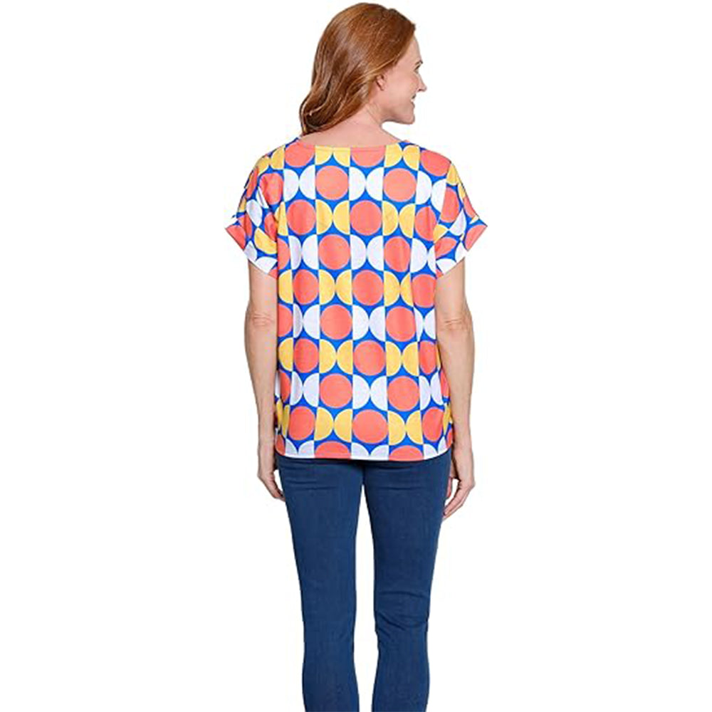 Woman wearing a colorful geometric patterned top on a white background