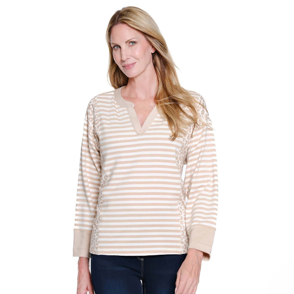 Woman wearing a beige and white striped long-sleeve shirt on a white background