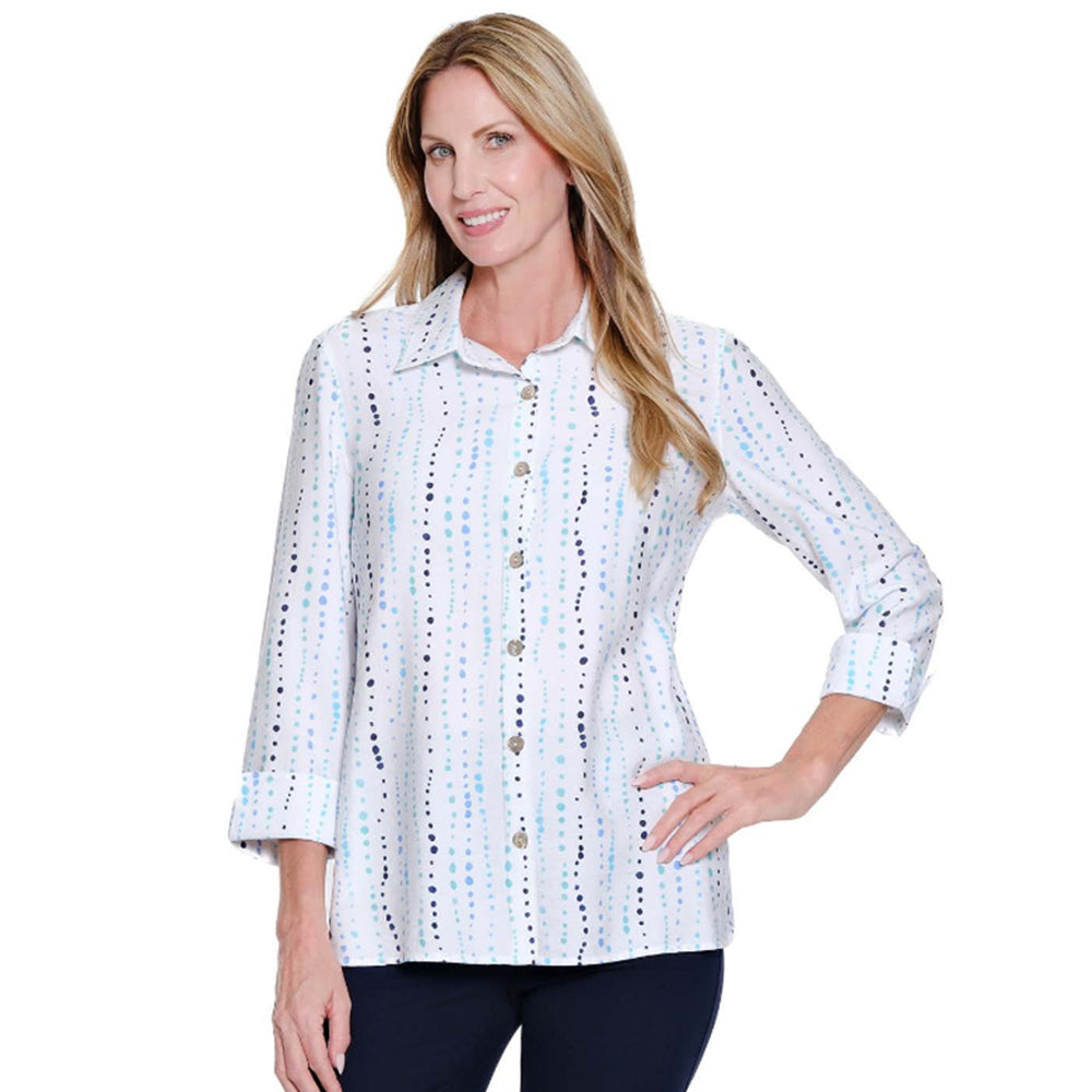 Woman wearing a white blouse with colorful patterns on a white background