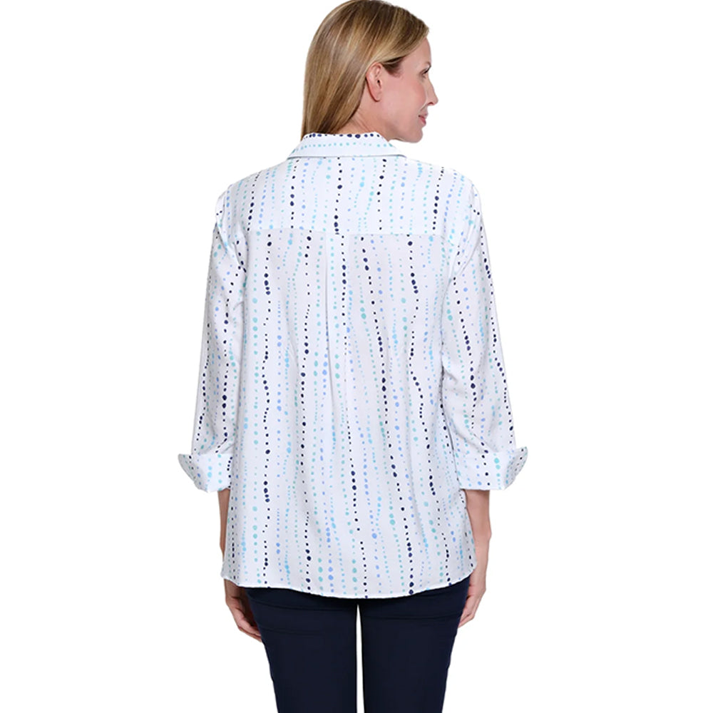 Woman wearing a white blouse with black and blue pattern on a white background