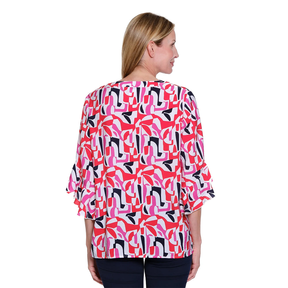 Woman wearing a colorful patterned blouse on a white background
