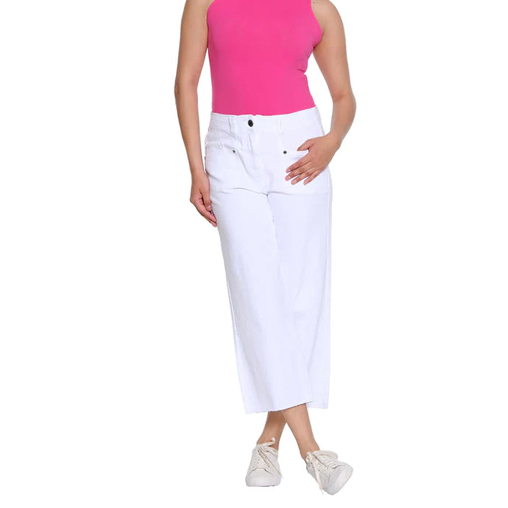 Person wearing a pink top and white pants on a white background
