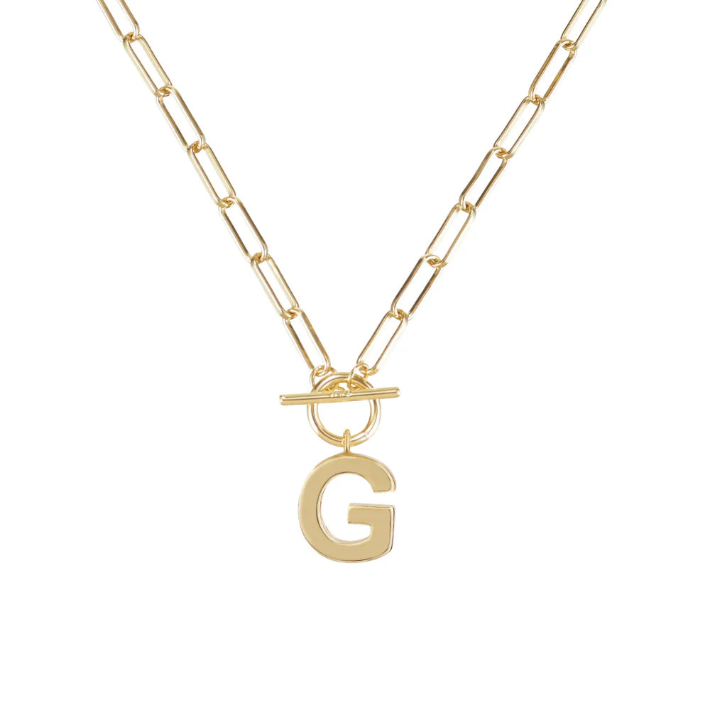 Gold necklace with a letter 'G' pendant on a white background