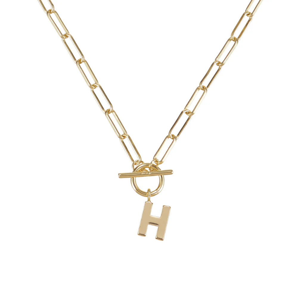Gold necklace with a 'H' pendant on a white background
