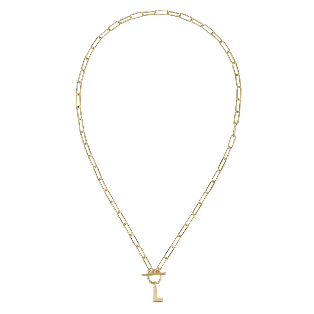 Gold chain necklace with a key pendant on a white background