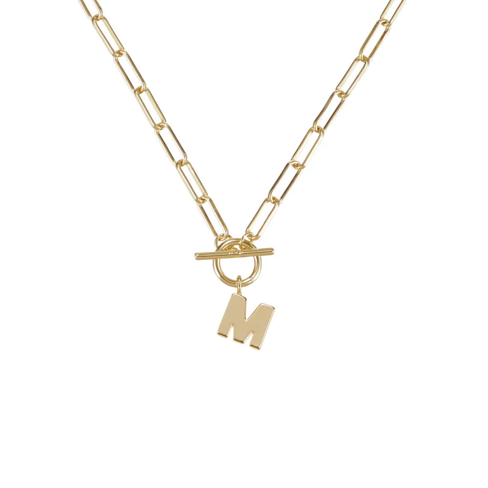 Gold necklace with a letter 'M' pendant on a white background