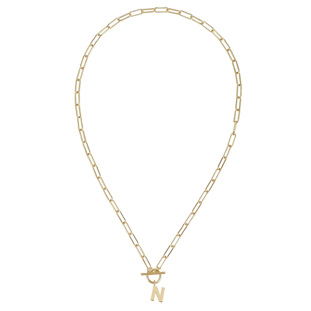 Gold necklace with a letter 'N' pendant on a white background