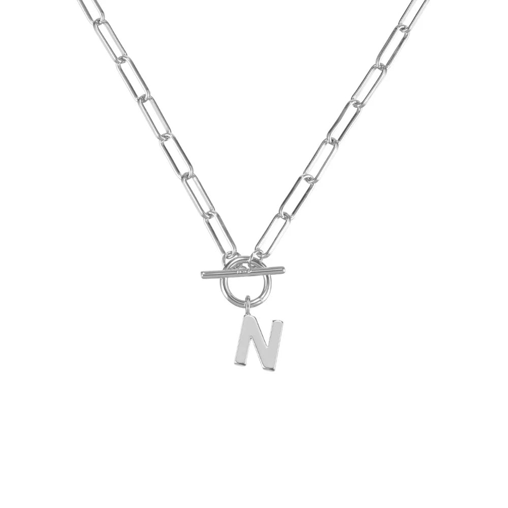 Silver necklace with a toggle clasp and 'N' pendant on a white background