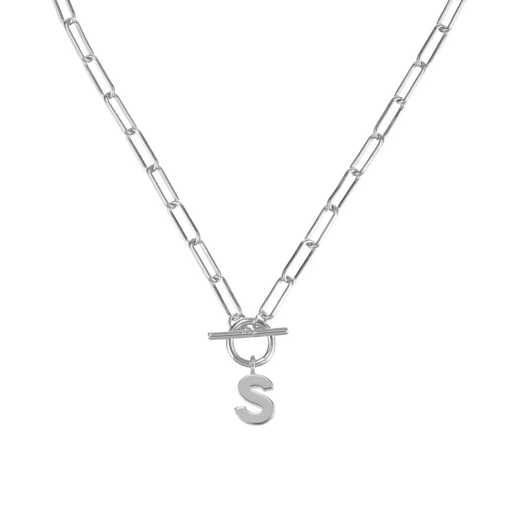Silver necklace with a letter 'S' pendant on a white background