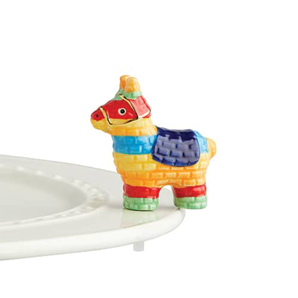 Colorful llama-shaped object on a white plate with a white background