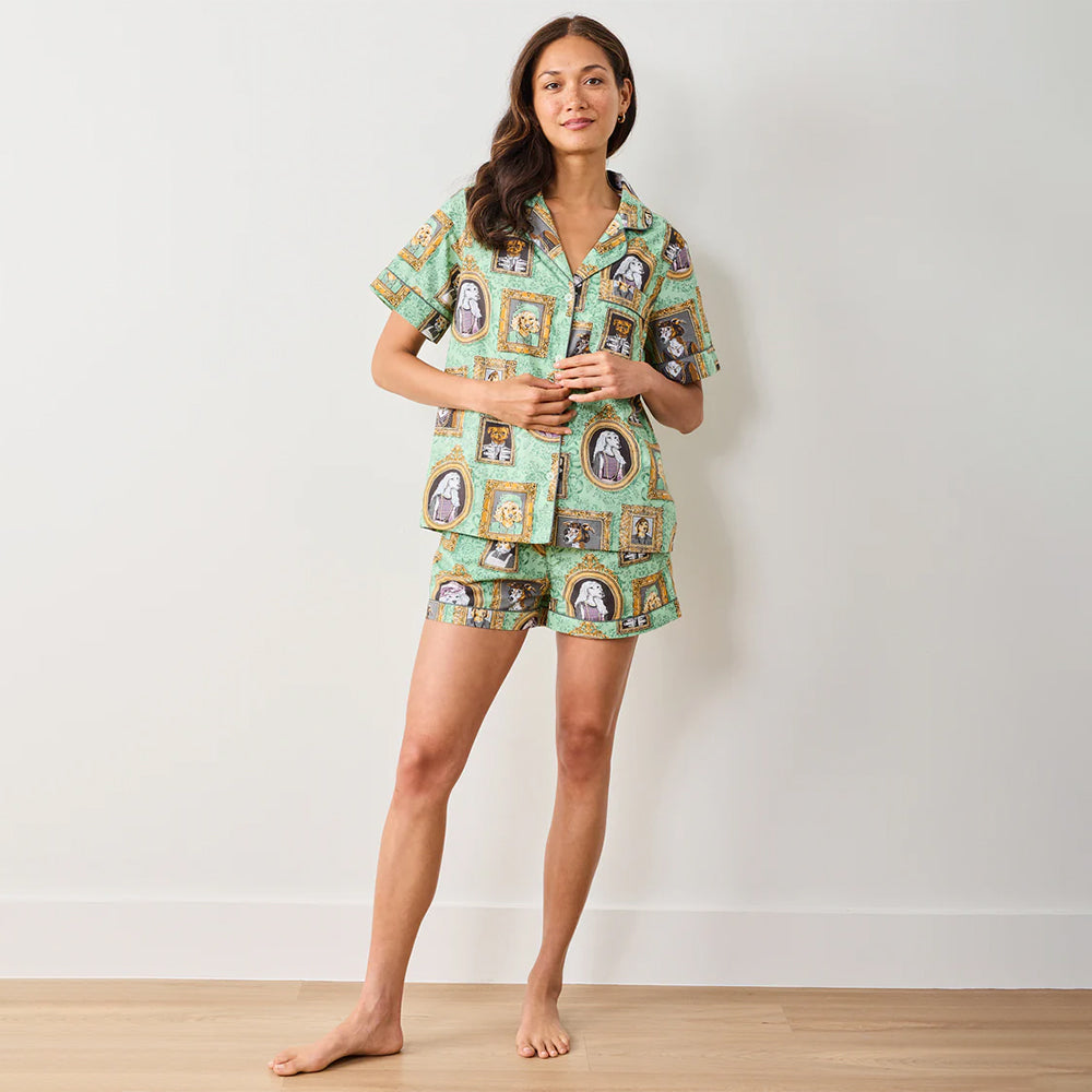 Woman wearing a patterned pajama set on a plain background