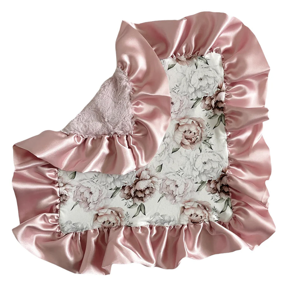 Floral blanket with pink satin ruffles on a white background