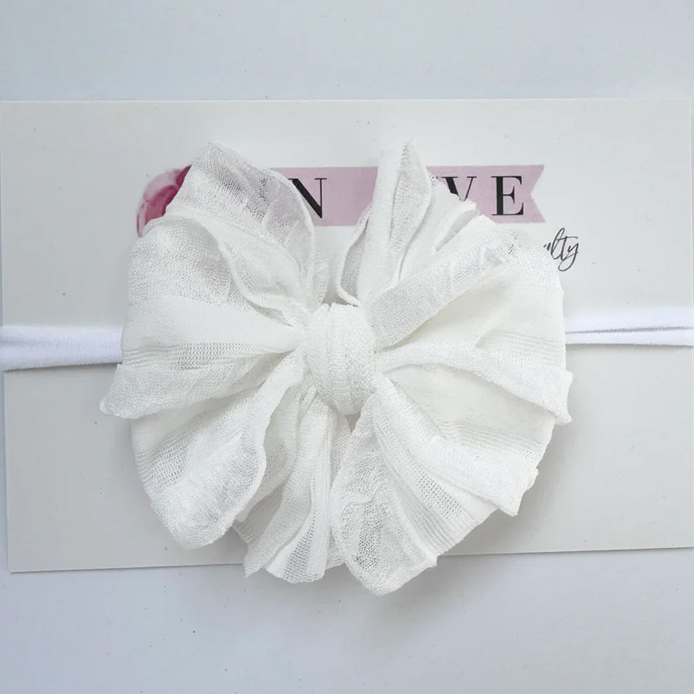 White lace bow headband on a white background
