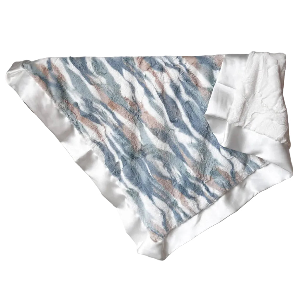 Textured fabric with blue and brown pattern draped over a rack against a white wall