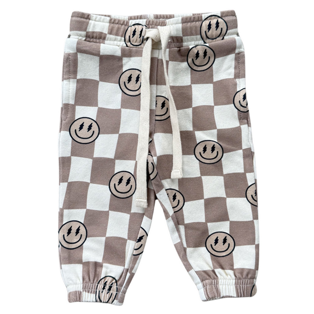 Checkered pants with smiley face pattern on a white background