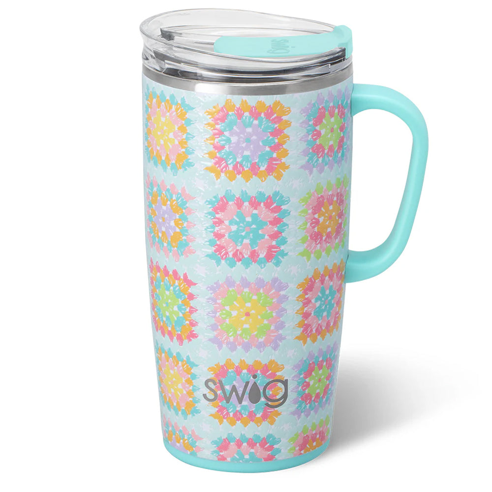Travel mug with colorful pattern and turquoise handle on a white background