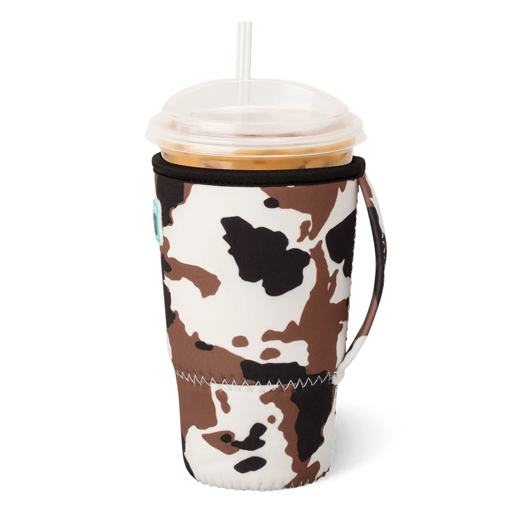 Coffee cup with a cow print sleeve on a white background