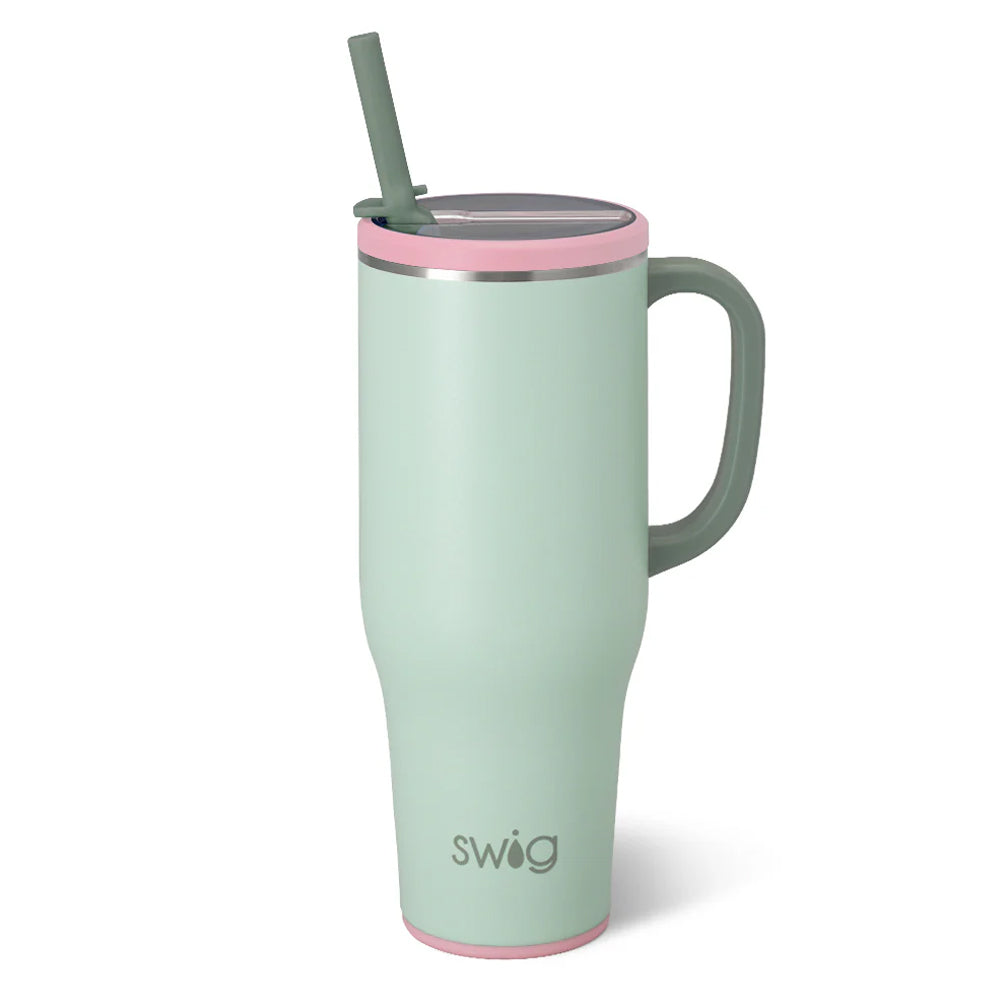 Mint green mug with pink rim and straw on a white background, featuring the 'swig' brand.