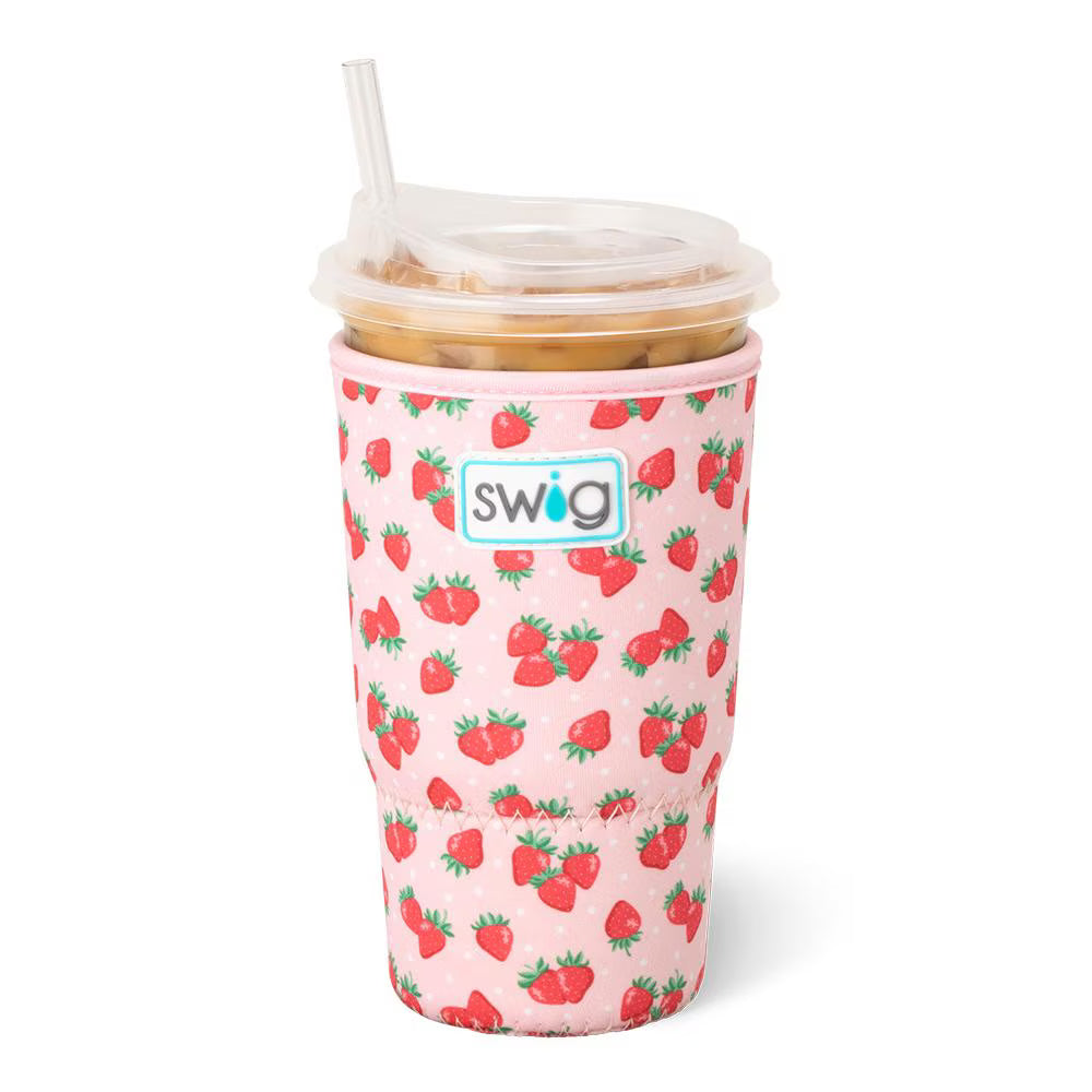 Pink tumbler with strawberry pattern and straw on a white background