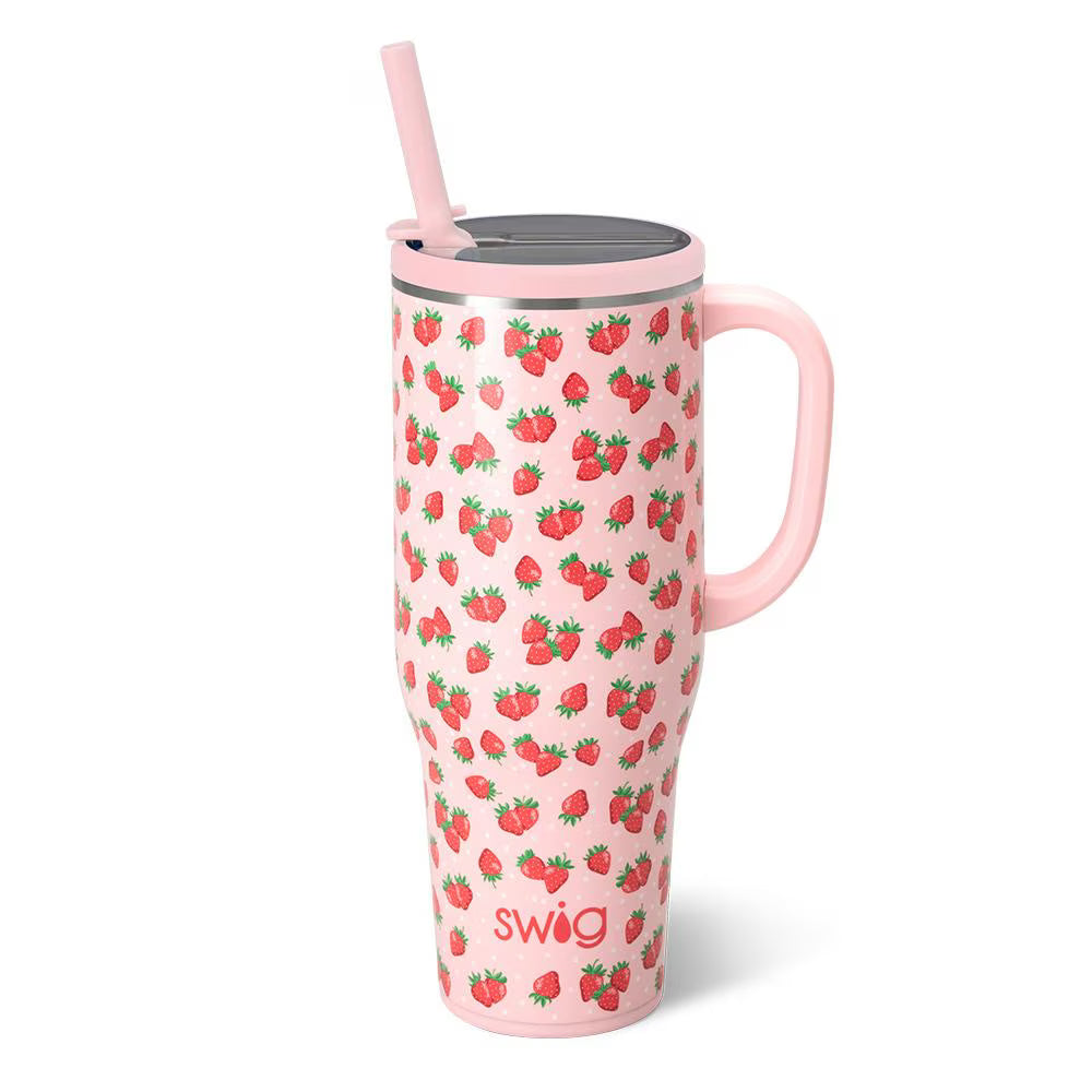 Pink tumbler with strawberry pattern and straw on a white background