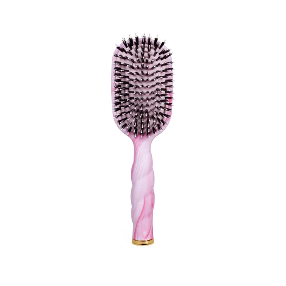 Hairbrush with pink handle and black bristles on a white background