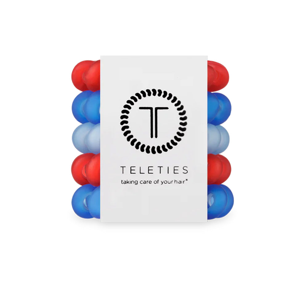 Stack of red and blue hair ties with Teleties branding on a white background