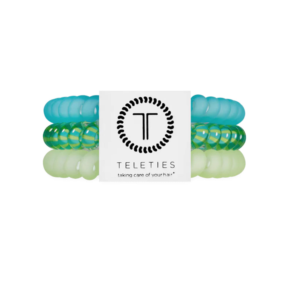 Set of green and clear hair ties with a Teleties branded label on a white background