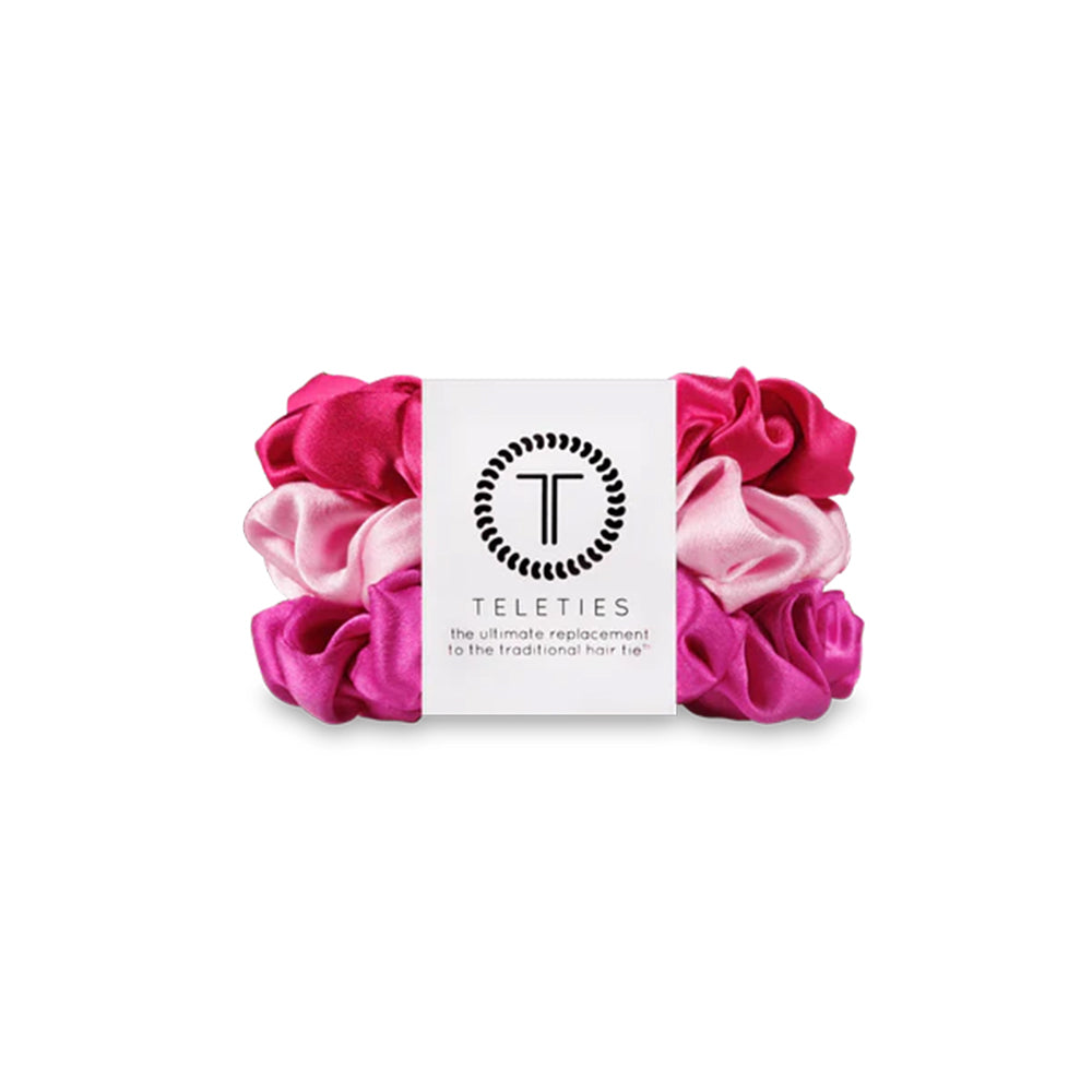 Pink and white scrunchies with a Teleties label on a white background