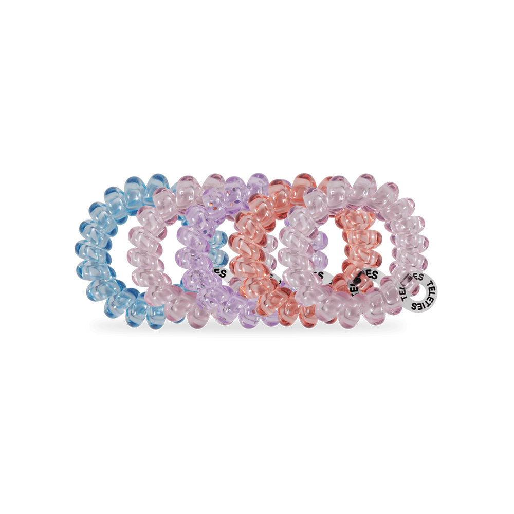 Set of colorful hair ties in pastel colors on a white background