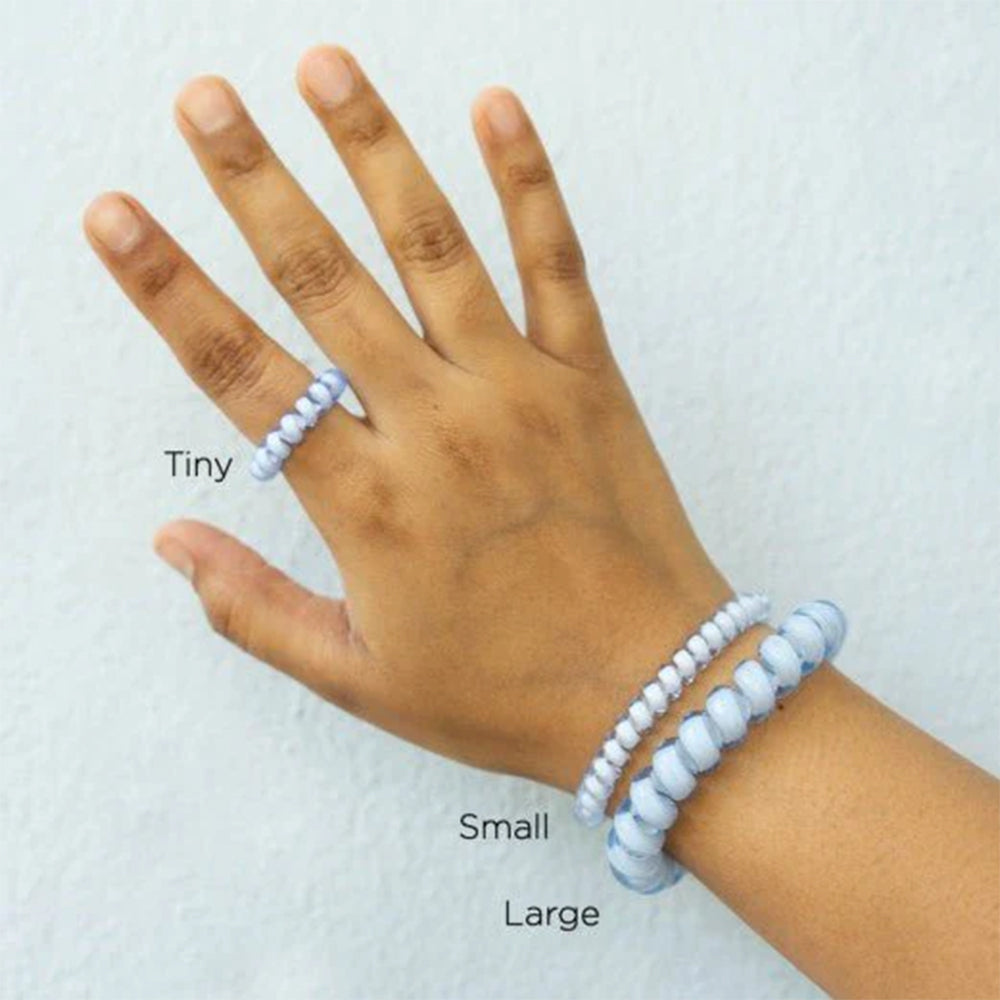 Hand wearing a bracelet with labeled sizes 'Tiny', 'Small', and 'Large' on a white background.