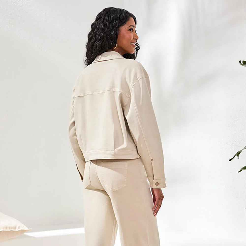 Woman wearing a beige jacket and pants on a white background