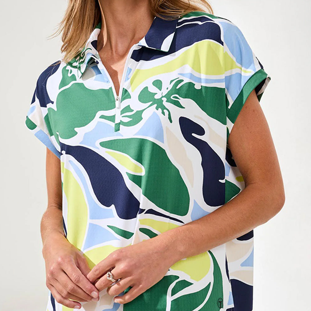 Woman wearing a colorful patterned shirt with a neutral background