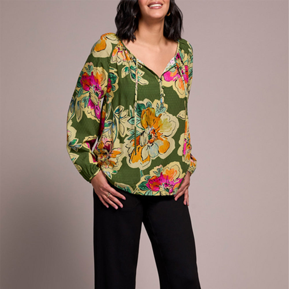 Woman wearing a floral blouse with a plain background