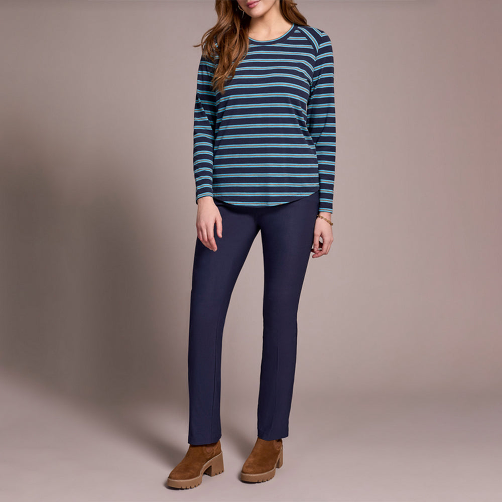 Person wearing a striped sweater and blue pants on a plain background