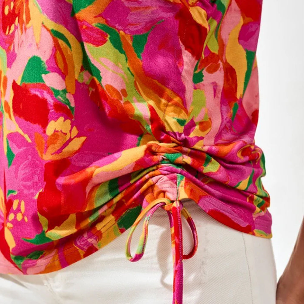 Colorful floral top with a tie detail on a white background