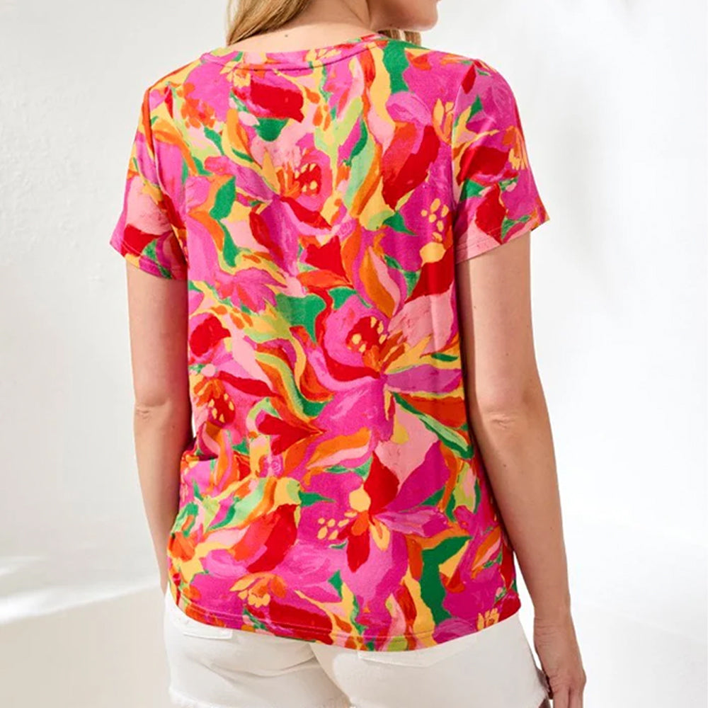 Person wearing a colorful floral t-shirt against a white background